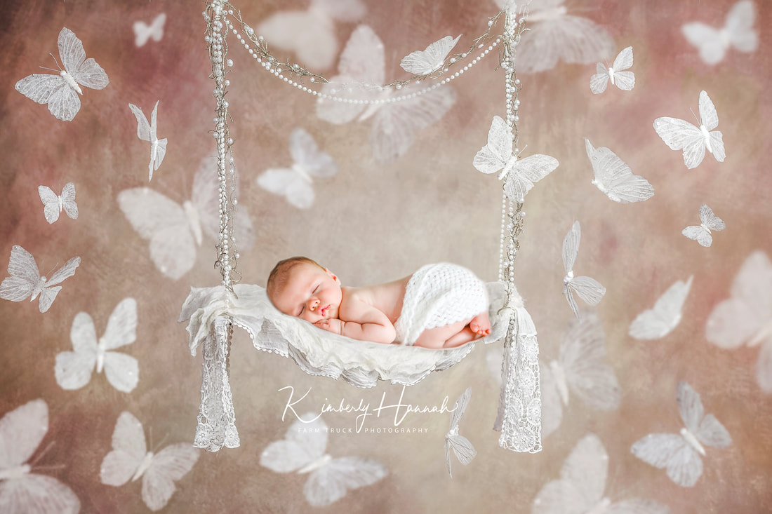 baby in a swing.  Newborn Portrait photographer